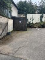 a black gate in a parking lot next to a fence at Cosy Loire, T2 neuf, front de Loire ,vue cathédrale,5min à pied centre ville et parking privé in Orléans