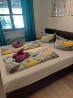 a bed with two stuffed animals on top of it at Ferienwohnung am Walchensee in Walchensee