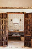 two sinks in a bathroom with two open doors at Casa La Siesta in Vejer de la Frontera