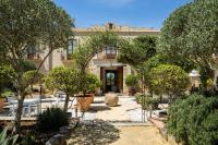 a courtyard with trees and a building at Casa La Siesta in Vejer de la Frontera