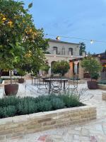 a courtyard with a table and chairs and trees at Casa La Siesta in Vejer de la Frontera