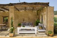 an outdoor patio with couches and a table at Casa La Siesta in Vejer de la Frontera