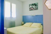a bedroom with a bed with a blue head board at JV APPART** 5 Pers 5mn Luz 15 mn Ardiden in Luz-Saint-Sauveur