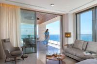 a woman is walking through a living room at Four Seasons Hotel in Limassol