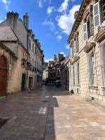 an empty street in a city with buildings at Le Petit Hernoux Centre historique in Dijon