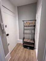 a hallway with a shelf with shoes on it at Le Petit Hernoux Centre historique in Dijon