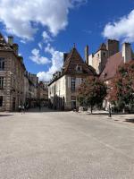 an empty street in a city with buildings at Le Petit Hernoux Centre historique in Dijon