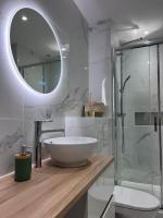 a bathroom with a large bowl sink and a mirror at Le Petit Hernoux Centre historique in Dijon