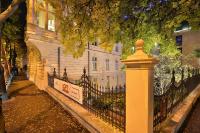 a black fence in front of a white building at Wilson Palace by LOFT in Bratislava