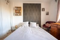 a bedroom with a large white bed and a chair at Apt lumineux et très cosy avec balcon by Weekome in Marseille