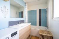 a bathroom with a sink and a mirror and a tub at Apt lumineux et très cosy avec balcon by Weekome in Marseille
