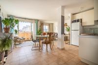 a kitchen and living room with a table and chairs at Apt lumineux et très cosy avec balcon by Weekome in Marseille