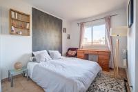 a bedroom with a bed and a desk and a window at Apt lumineux et très cosy avec balcon by Weekome in Marseille