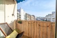 a balcony with a wooden fence and a chair at Apt lumineux et très cosy avec balcon by Weekome in Marseille