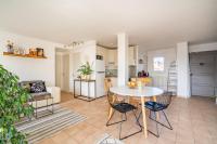 a kitchen and living room with a table and chairs at Apt lumineux et très cosy avec balcon by Weekome in Marseille