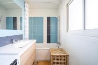 a bathroom with a sink and a tub and a mirror at Apt lumineux et très cosy avec balcon by Weekome in Marseille