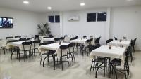 a dining room with white tables and chairs at Hotel Bellavista in Paulo Afonso