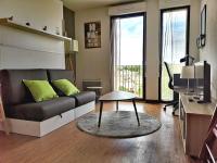a living room with a couch and a table at Studio - Centre Ville - free parking in Montpellier
