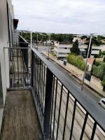a balcony of a building with a view of a street at Studio - Centre Ville - free parking in Montpellier