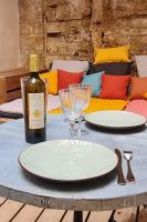 a table with two plates and a bottle of wine at Mes à Moi in Pezenas - Studio &amp; patio privatif - O Pitchoun in Pézenas