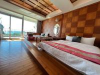a bedroom with a large bed and a large window at Ming Jun Homestay in Eluan
