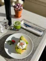a plate of food with a egg on a table at The Principal Madrid, Small Luxury Hotels in Madrid