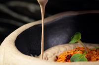a wooden spoon is being inserted into a bowl of food at UMusic Hotel Madrid in Madrid