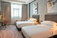 Postel nebo postele na pokoji v ubytování Asiana Grand Hotel