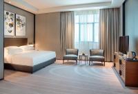 Postel nebo postele na pokoji v ubytování Asiana Grand Hotel