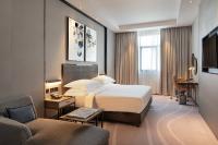 Postel nebo postele na pokoji v ubytování Asiana Grand Hotel