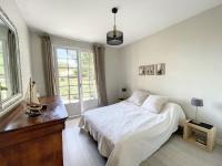 a white bedroom with a bed and a window at Maison Saint-Pair-sur-Mer, 5 pièces, 8 personnes - FR-1-361-56 in Saint-Pair-sur-Mer