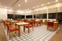 a restaurant with tables and chairs in a room at Park Dedeman Denizli in Denizli