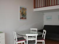 a room with a table and chairs and a couch at Maison La Tranche-sur-Mer, 2 pièces, 4 personnes - FR-1-22-182 in La Tranche-sur-Mer