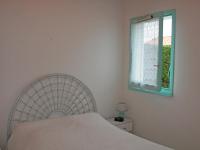 a bedroom with a white bed and a window at Maison La Tranche-sur-Mer, 2 pièces, 4 personnes - FR-1-22-182 in La Tranche-sur-Mer