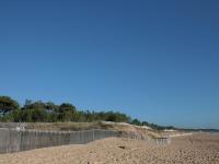 a fence on a beach next to the ocean at Maison La Tranche-sur-Mer, 2 pièces, 4 personnes - FR-1-22-182 in La Tranche-sur-Mer