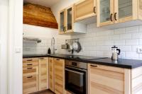 a kitchen with wooden cabinets and a black counter top at Gut Boltenhof in Fürstenberg