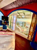 a bedroom with a large window with a view of the ocean at Ming Jun Homestay in Eluan