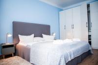 a bedroom with a large bed with white cabinets at Gut Boltenhof in Fürstenberg