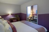 a bedroom with a large bed and a living room at Best Western Hotel de la Breche in Niort