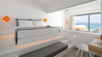 A bed or beds in a room at Seanfinity Beachfront Suites