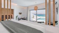 A bed or beds in a room at Seanfinity Beachfront Suites