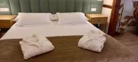 Postel nebo postele na pokoji v ubytování Hotel Boutique ADOLFO