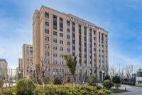 a building with a sign on the front of it at Joy Fall Hotel in Jiaozhou