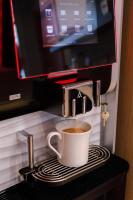 a cup of coffee in a coffee machine at Hôtel de Noailles in Lyon