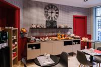 a kitchen with a counter with food on it at Hôtel de Noailles in Lyon