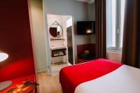 a hotel room with a red bed and a mirror at Hôtel de Noailles in Lyon