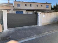 a black fence in front of a house at Maison la Londe in La Londe-les-Maures