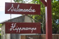 two signs that readulumerate and hurricanearma hanging from a pole at Salamandre et Hippocampe in Lanton