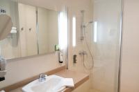 a bathroom with a sink and a shower at Hôtel Arcadia in Lannion