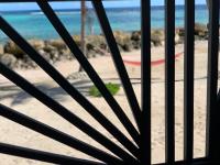 a view of the beach through a gate at Résidence Nature Ocean - M&amp;P Concept in Cadet